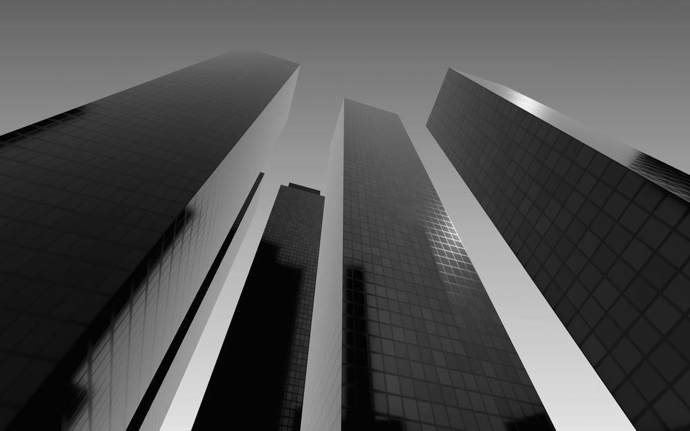 Torres de oficinas de vidrio vistas desde la calle contra un cielo claro